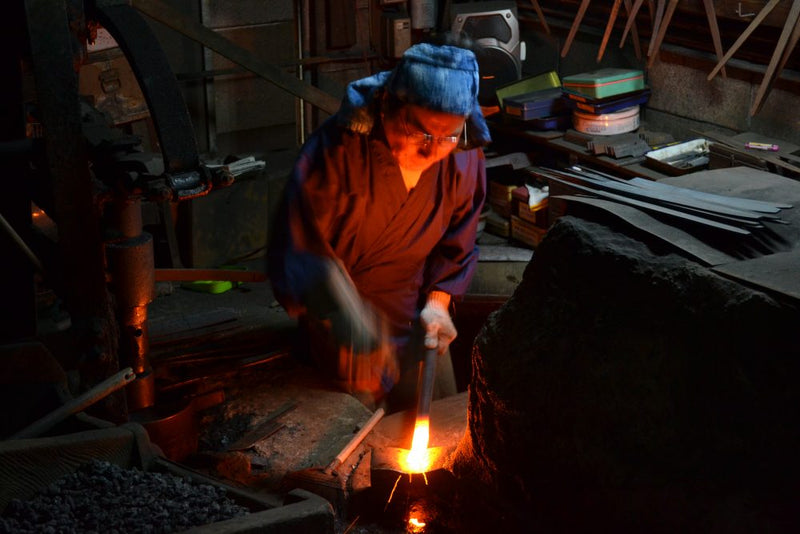 The smith Doi Itsuo in front of the forge.